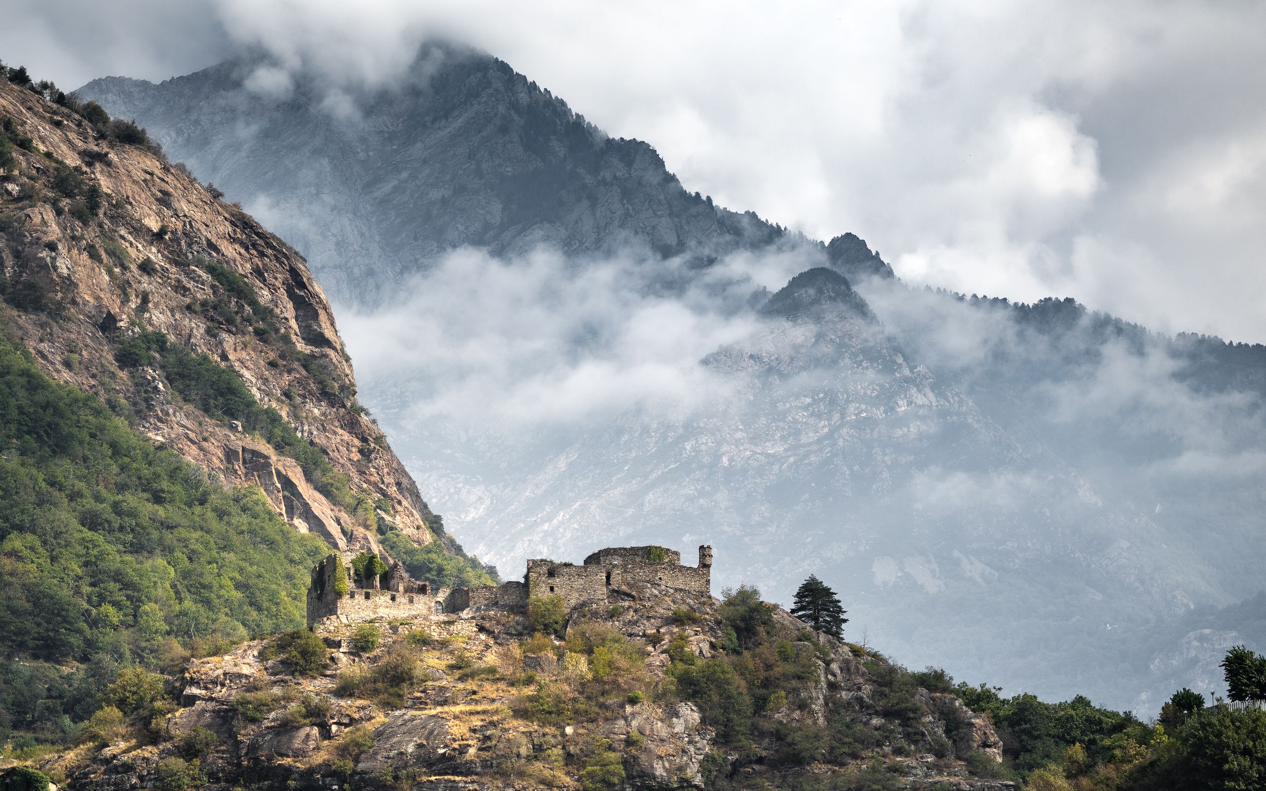 Mountain ruins in dark misty landscape