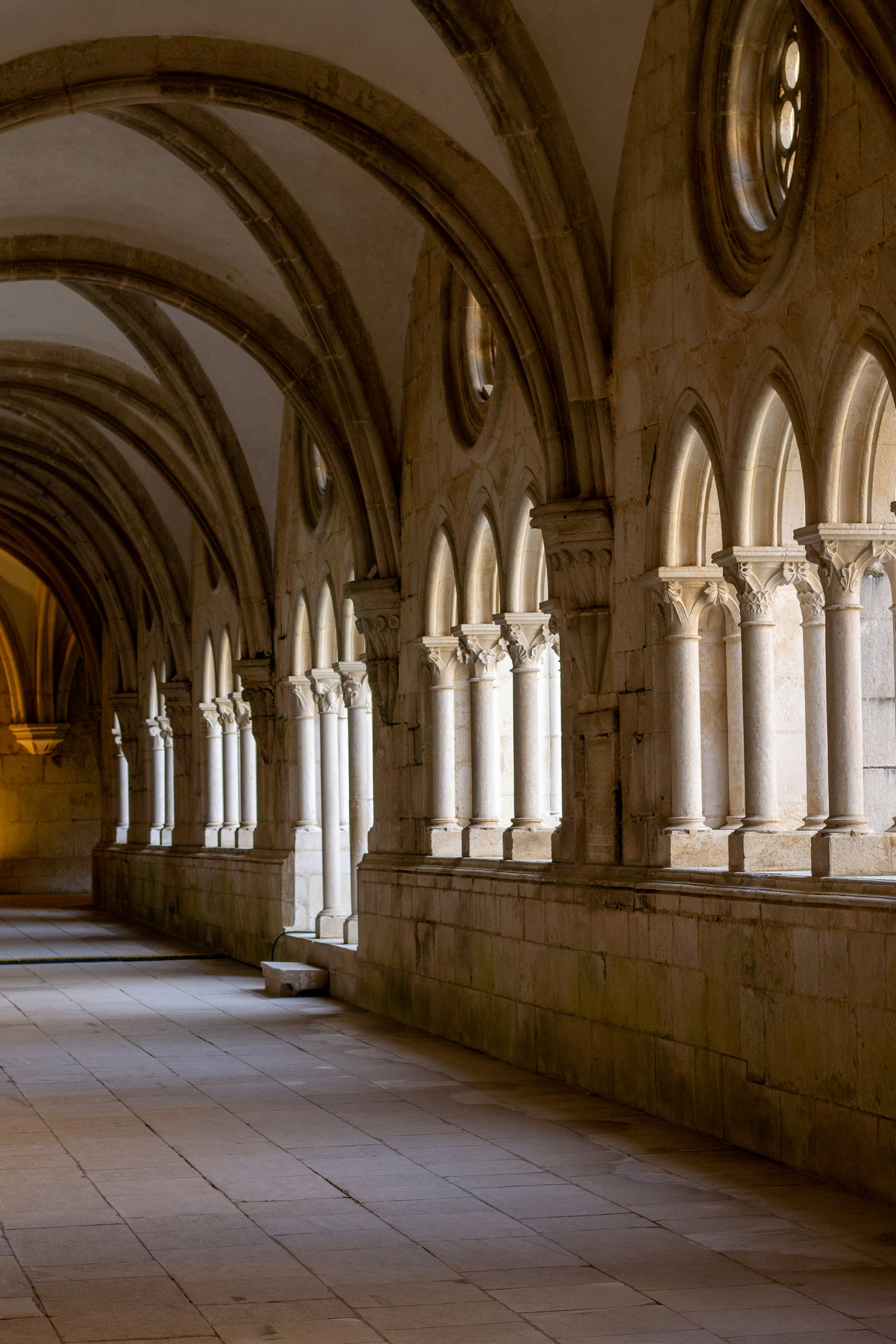 Monastery cloister stone arches Portugal — mountain monasteries ASHWANA The Fractured Elden by Aurelia da Serra